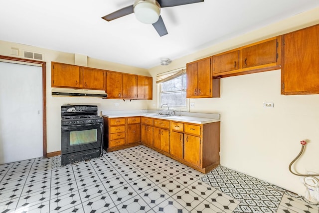 kitchen featuring black gas range, ceiling fan, and sink