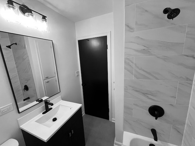 bathroom featuring vanity and tiled shower / bath