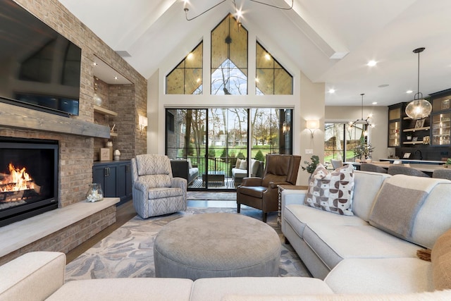 living area with high vaulted ceiling and a brick fireplace