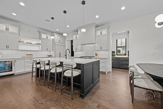 328 S Loomis St, Naperville, IL 60540 - kitchen featuring beverage cooler, light countertops, an island with sink, dark wood finished floors, and open shelves