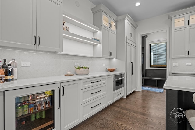 328 S Loomis St, Naperville, IL 60540 - kitchen featuring dark wood-style flooring, glass insert cabinets, white cabinets, oven, and tasteful backsplash