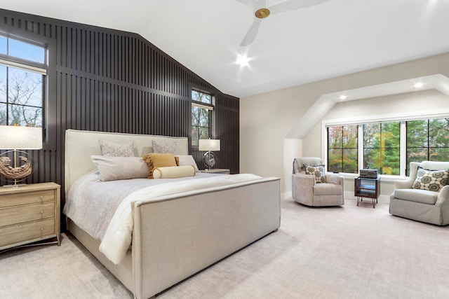 carpeted bedroom with multiple windows, ceiling fan, and vaulted ceiling