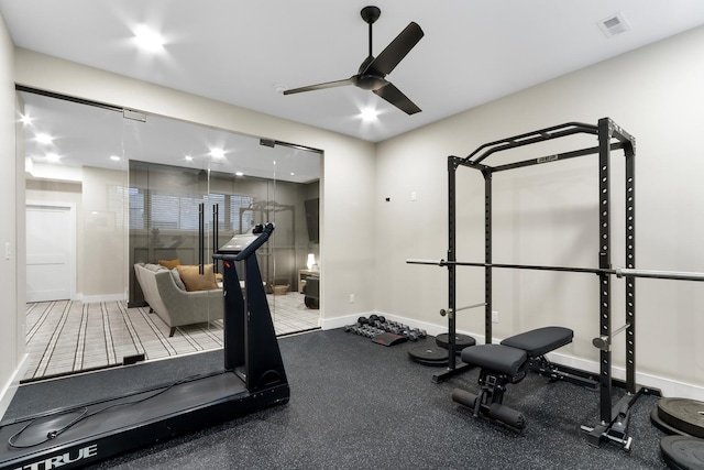 exercise area with visible vents, a ceiling fan, and baseboards