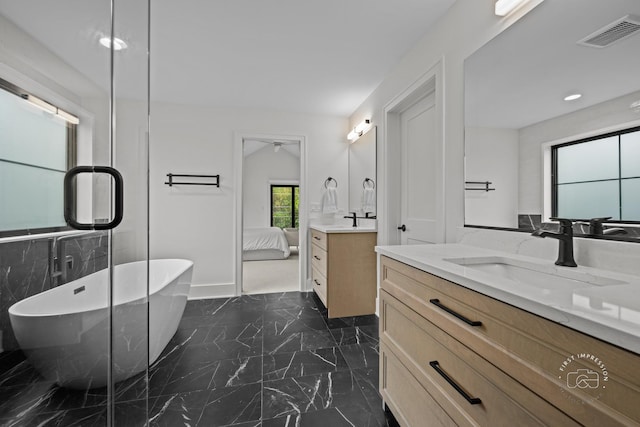 328 S Loomis St, Naperville, IL 60540 - bathroom featuring marble finish floors, two vanities, a freestanding tub, and ensuite bath