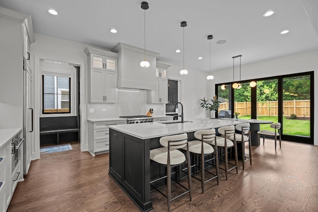328 S Loomis St, Naperville, IL 60540 - kitchen with dark wood-style flooring, light countertops, glass insert cabinets, and recessed lighting