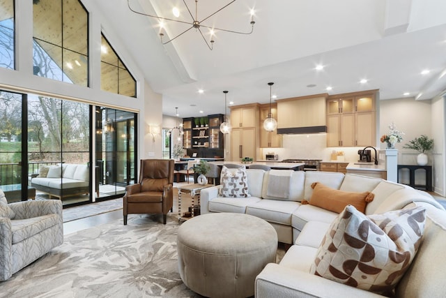 living room featuring recessed lighting, a notable chandelier, and high vaulted ceiling