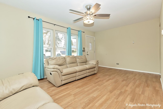 living room with ceiling fan and light hardwood / wood-style floors