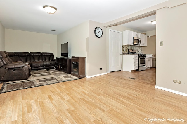 living room with light hardwood / wood-style flooring