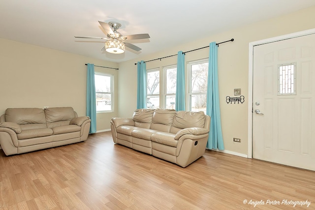 living room featuring ceiling fan and light hardwood / wood-style floors