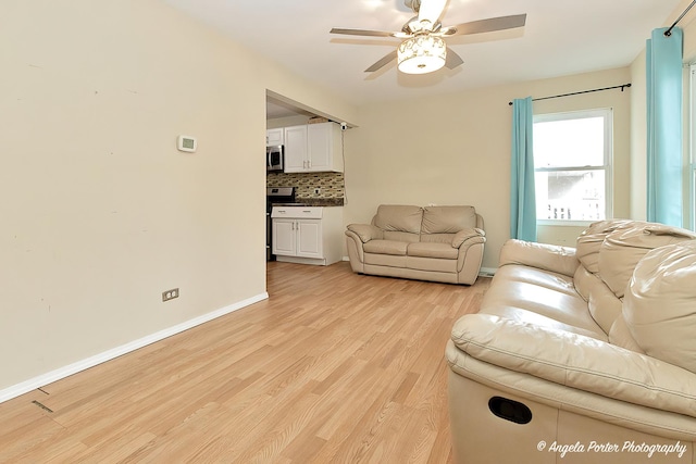 living room featuring light hardwood / wood-style floors and ceiling fan