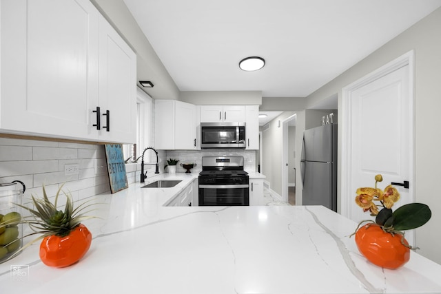 kitchen featuring white cabinets, appliances with stainless steel finishes, and sink