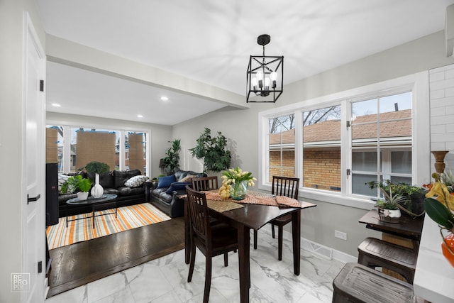 dining space featuring a chandelier and plenty of natural light