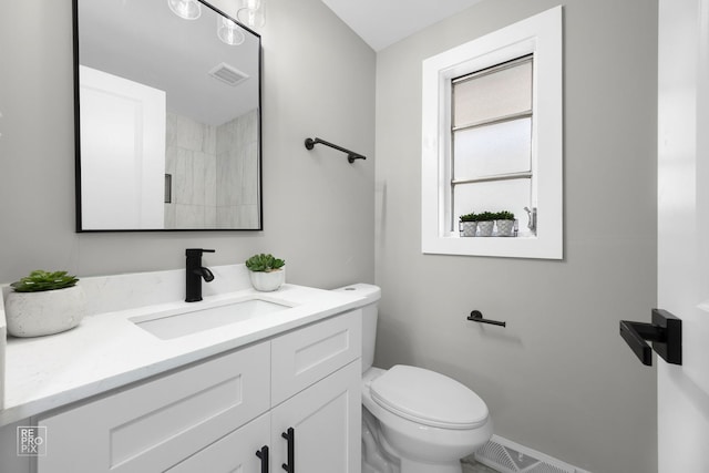 bathroom with toilet and vanity