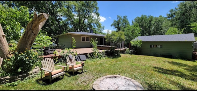 view of yard featuring a wooden deck and an outdoor fire pit