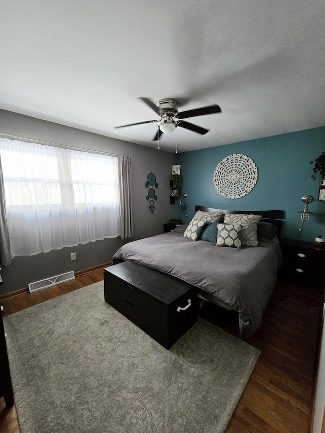 bedroom featuring dark hardwood / wood-style floors and ceiling fan