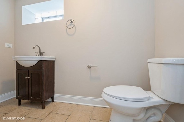 bathroom with toilet and vanity