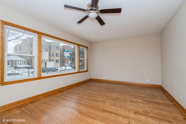 empty room featuring light hardwood / wood-style flooring and ceiling fan