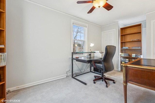 carpeted home office with crown molding and ceiling fan