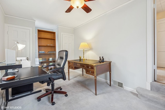 carpeted office space featuring crown molding and ceiling fan