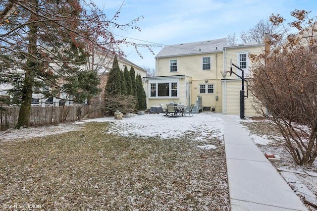 view of snow covered rear of property