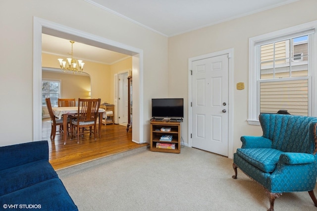 interior space featuring crown molding, carpet floors, and a chandelier