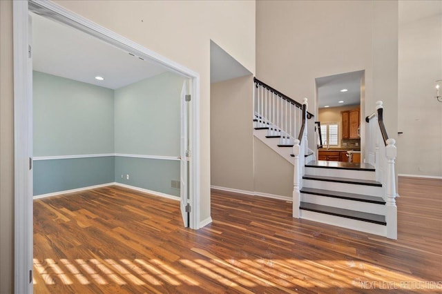 staircase with hardwood / wood-style floors