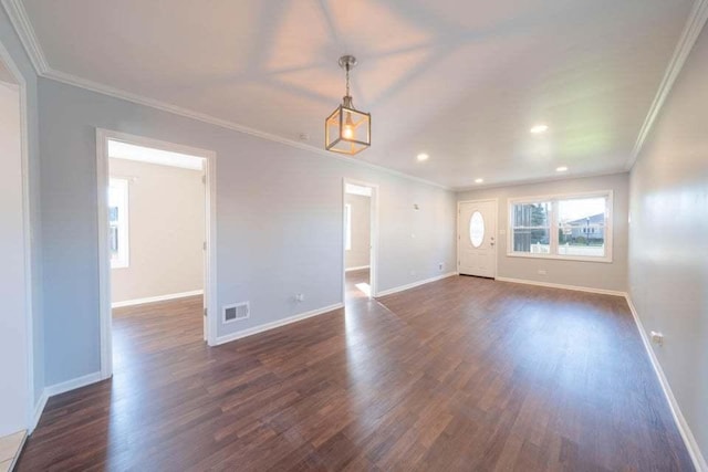 empty room with ornamental molding and dark wood-type flooring