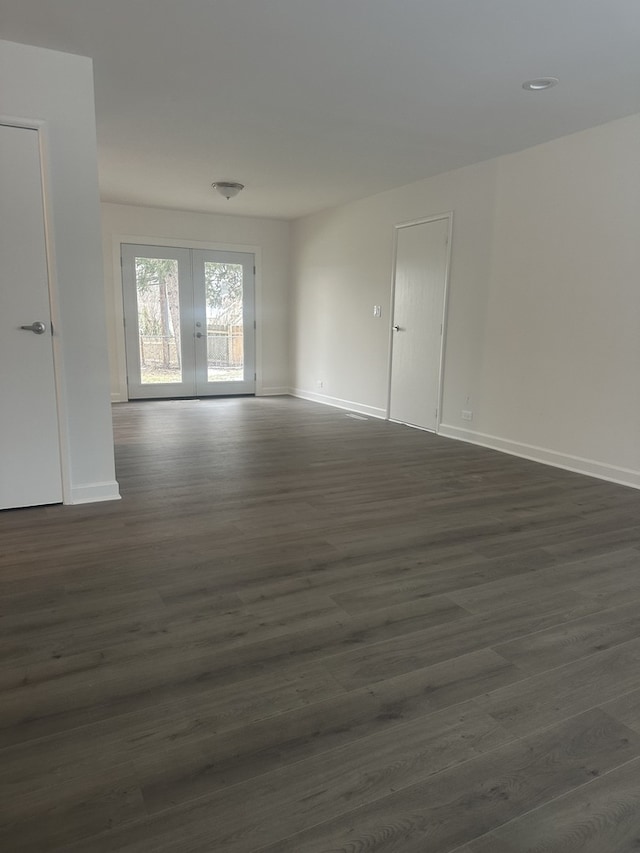 unfurnished room featuring dark hardwood / wood-style floors and french doors