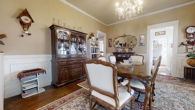 dining area featuring a chandelier, crown molding, and dark wood-type flooring