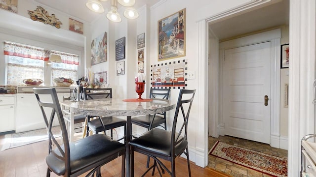 dining space with a notable chandelier and hardwood / wood-style flooring