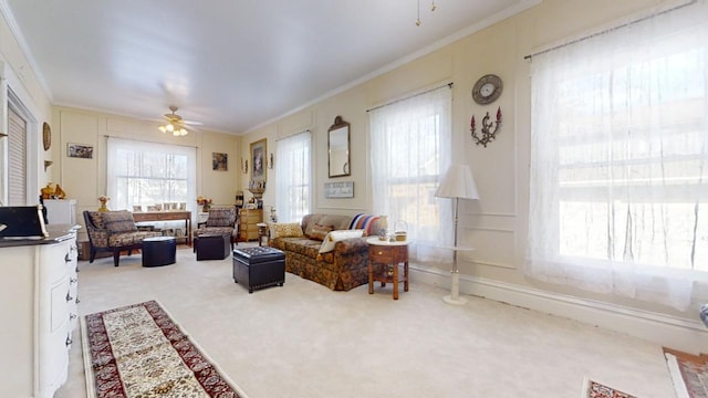 carpeted living room with crown molding and ceiling fan