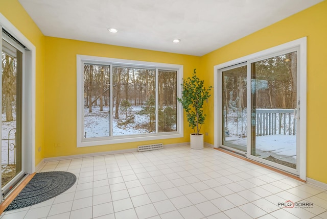 interior space featuring light tile patterned flooring and a healthy amount of sunlight