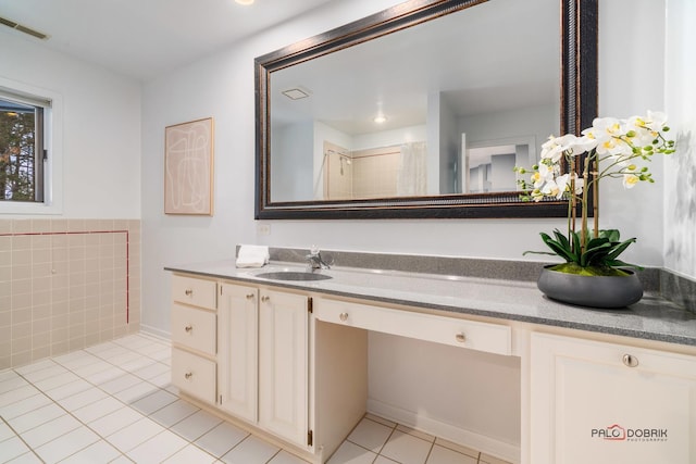 bathroom featuring tile patterned flooring and vanity