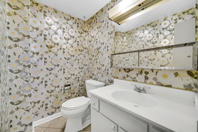 bathroom with tile patterned floors, vanity, and toilet