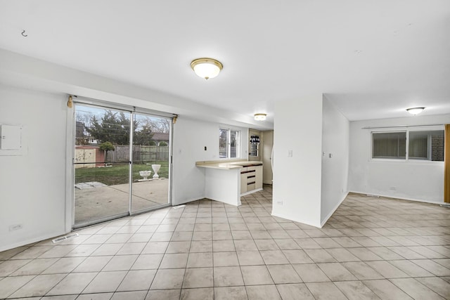 unfurnished living room featuring light tile patterned floors