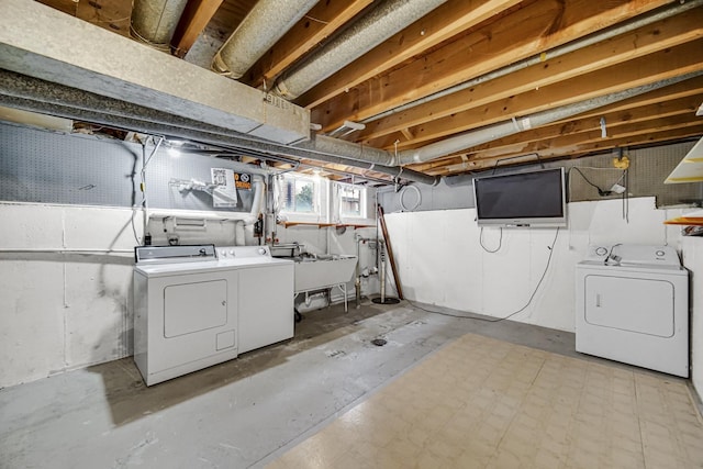 clothes washing area with sink and independent washer and dryer