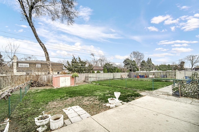 view of yard with a storage shed and a patio area