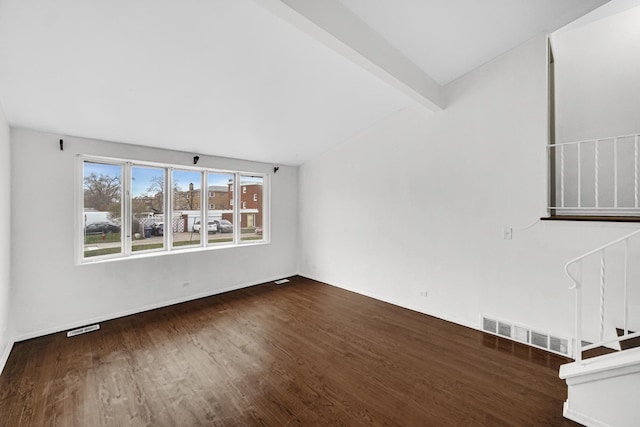 unfurnished living room featuring vaulted ceiling with beams and dark hardwood / wood-style flooring