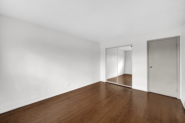 unfurnished bedroom with dark hardwood / wood-style floors