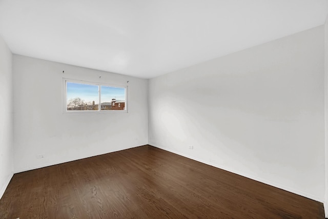 unfurnished room with dark hardwood / wood-style flooring