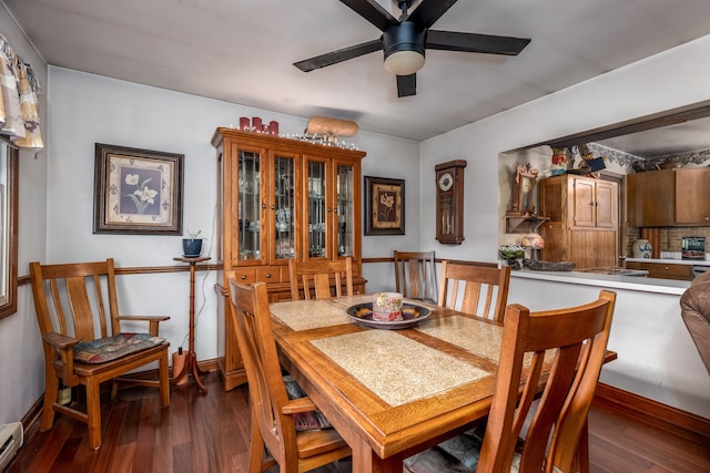 dining room with ceiling fan, a baseboard radiator, baseboards, and wood finished floors