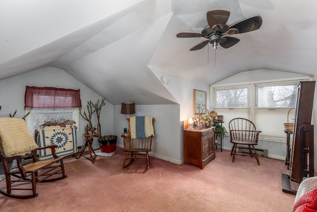 living area with a ceiling fan, vaulted ceiling, light colored carpet, and baseboards