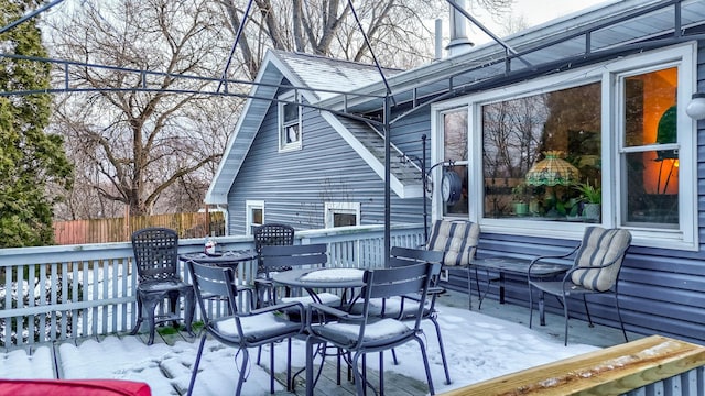 snow covered deck with fence