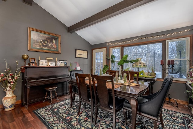 dining room featuring vaulted ceiling with beams, baseboards, and wood finished floors