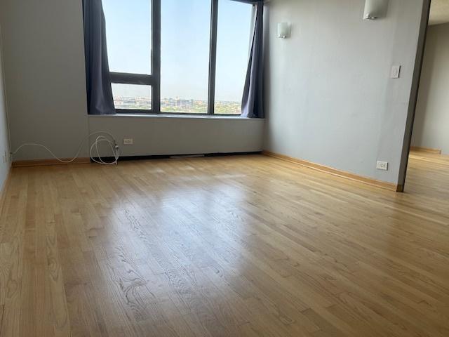 unfurnished room with light hardwood / wood-style flooring