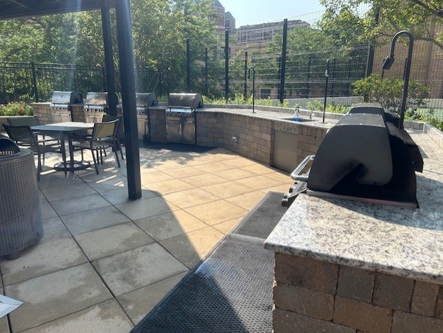 view of patio / terrace featuring an outdoor kitchen and a grill