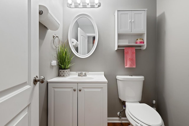 bathroom featuring toilet and vanity