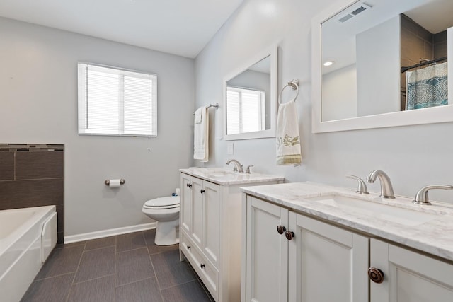 bathroom with toilet, vanity, and a shower with shower curtain