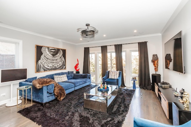 living room with wood-type flooring and ornamental molding