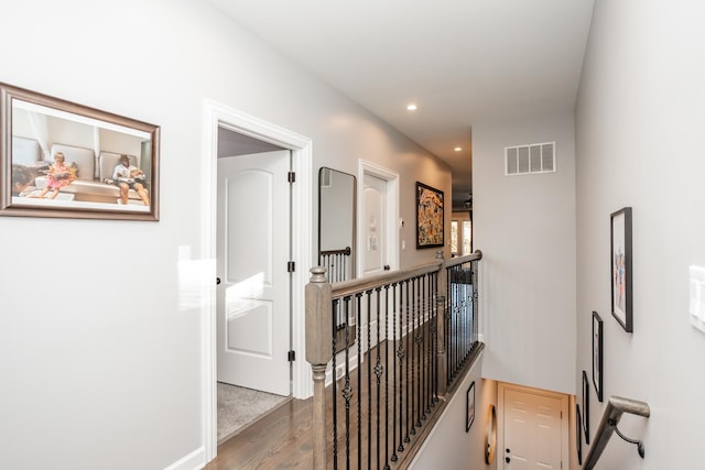 hall with hardwood / wood-style floors